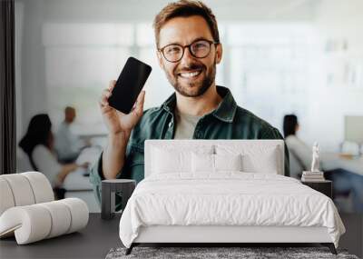 Business man recommending a mobile phone in an office Wall mural