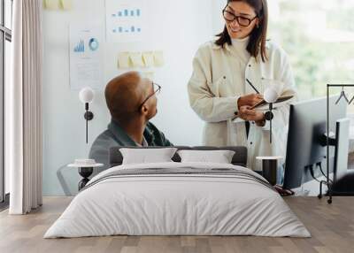 Business man talking to his manager in an office Wall mural