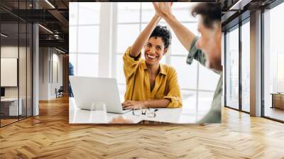 Business people celebrating success in an office Wall mural