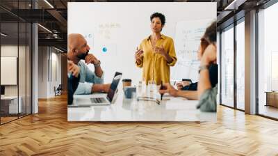 Business woman giving a speech in a boardroom meeting Wall mural