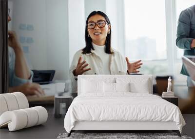 Business woman having a discussion with her team in an office Wall mural