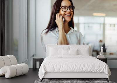 Business woman having a phone call in an office Wall mural