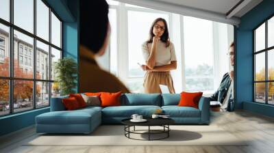 Business woman listening to a discussion in a team meeting Wall mural