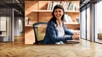 Businesswoman smiling while working from home Wall mural