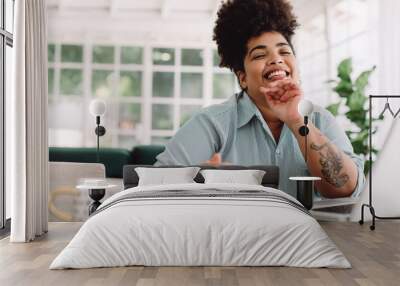 Cheerful woman sitting at home office desk Wall mural