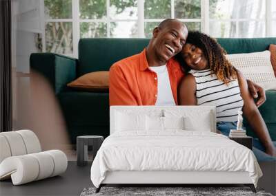 Couple laughing together at home Wall mural