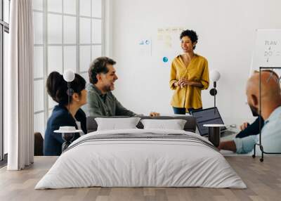 Diverse business people talking in a meeting. Business team having a discussion in a boardroom Wall mural