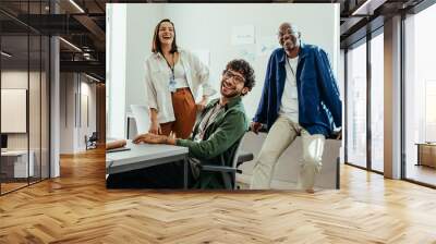 Diverse happy team of employees enjoying work at modern corporate office Wall mural