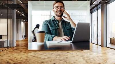 Entrepreneur making a phone call while working in an office Wall mural