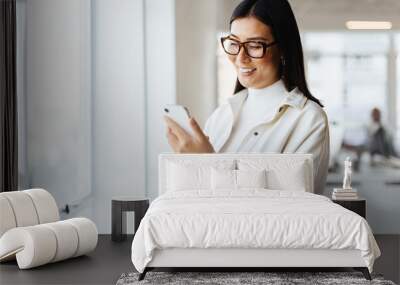 Female entrepreneur reading a text message on her mobile phone Wall mural