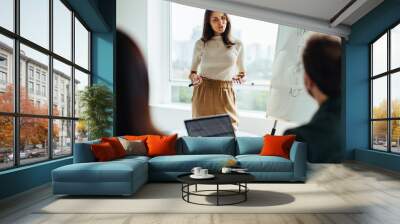 Female professional giving a presentation in an office Wall mural