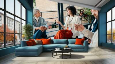 Group of diverse people talking in a casual office meeting in a modern workplace Wall mural