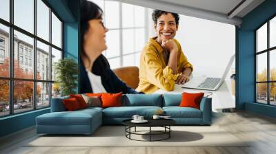 Happy business woman talking to her colleague in a meeting Wall mural