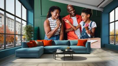 Happy family enjoying ice cream together at a cafe Wall mural