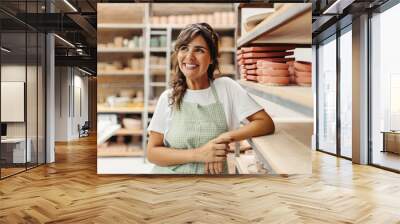 Happy female ceramist contemplating new ideas for her pottery Wall mural