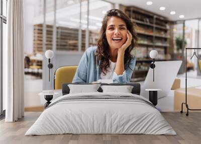 Happy online store manager using a smartphone in a warehouse Wall mural