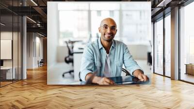 Male designer sitting at a table in an office Wall mural