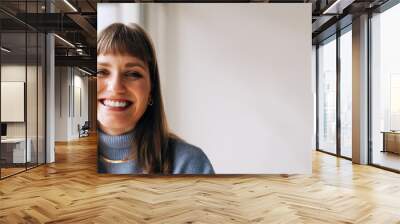 Portrait of a cheerful businesswoman smiling at the camera Wall mural