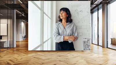 Portrait of woman entrepreneur at office Wall mural