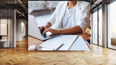 Professional businesswoman working remotely on a laptop in a cafe Wall mural