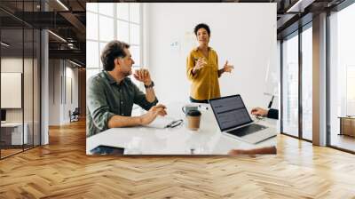 Professional woman discusses a project with her team Wall mural