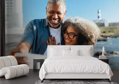 Retired happy pair taking a selfie on vacation by the ocean in Bahia Wall mural