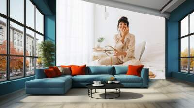 Smiling woman doing skin care at home Wall mural