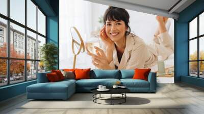 Smiling woman drinking wine after beauty care Wall mural