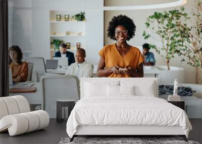 Successful afro-haired woman in modern office using smartphone Wall mural