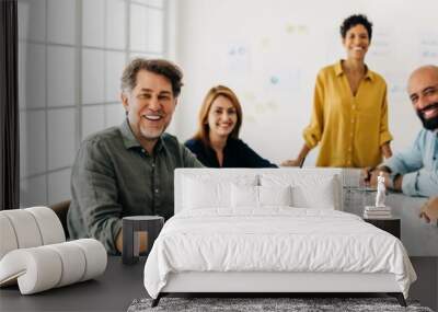 Successful business team sitting in a boardroom Wall mural