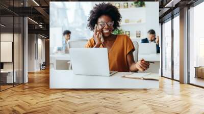 Successful businesswoman using modern technology in office Wall mural