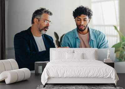 Two professional men collaborating in modern office using tablet and laptop Wall mural