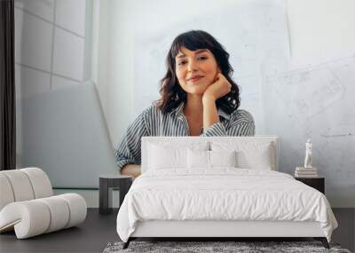 Woman architect sitting at office desk Wall mural