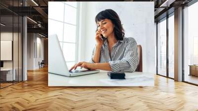 Woman entrepreneur working in office Wall mural