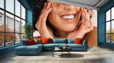 Woman exfoliating her skin with coffee scrub Wall mural