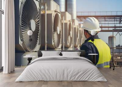  An engineer inspecting air conditioning units on the roof of a factory. Climate control. Wall mural