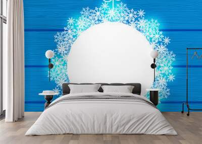 Christmas round frame made in snowflakes on blue wooden backgrou Wall mural