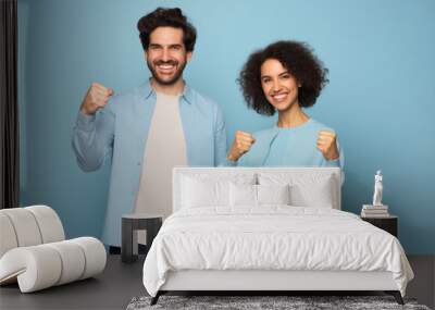 friends smiling young girl and guy with clenched fists in blue clothes Wall mural