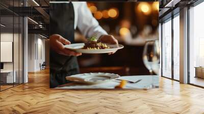 Waiter serving meat on a plate. Wall mural