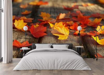 Crisp autumn leaves scattered on a wooden surface showcasing a vibrant array of colors that highlight the beauty of the changing season Wall mural