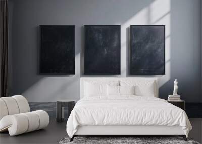 Three dark posters next to a white wall with mirrors Wall mural