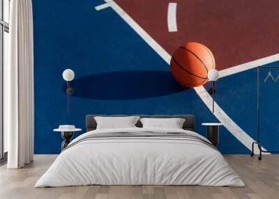 An orange ball on basketball court Wall mural