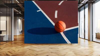 An orange ball on basketball court Wall mural