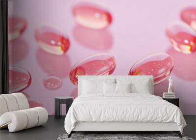 Macro of Transparent Vitamin Capsules Against Soft Pink Background Emphasizing Skin Health Wall mural