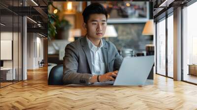 Asian male, young professional, typing on laptop in a modern business office, epic editorial Wall mural