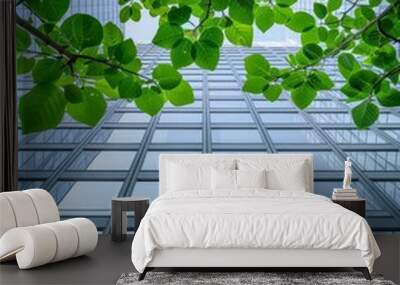 Ecofriendly building in the modern city Green tree branches with leaves and sustainable glass building for reducing heat and carbon dioxide Office building with green environment G Wall mural