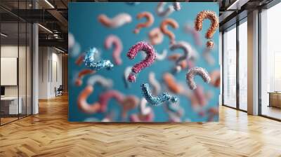 A captivating image of various colorful question marks floating against a blue background, symbolizing curiosity, confusion, and the quest for knowledge. Wall mural