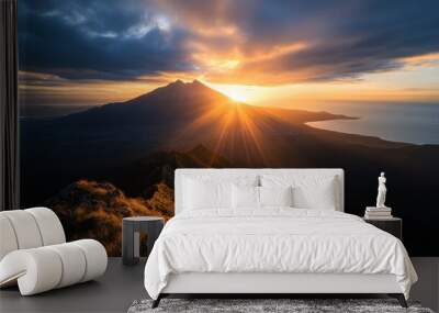 A stunning sunrise casts golden light across a mountain landscape and sea, symbolizing new beginnings and the breathtaking beauty of the natural world. Wall mural