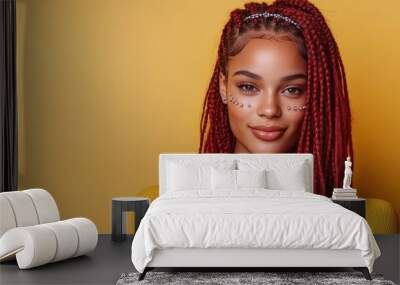 A young woman with red braids adorned with gems poses against a bold yellow backdrop, exemplifying personal style and artistic expression in a vibrant, modern context. Wall mural