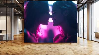 Artistic capture of two silhouettes leaning toward each other, set against a neon-lit background, representing intimacy and human connection in a contemporary setting. Wall mural